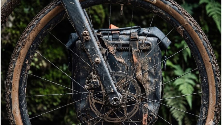 Close-up van een Anything Cage tas gemonteerd op de speciale 3-pack bevestigingspunten op een gravelbike voorvork.